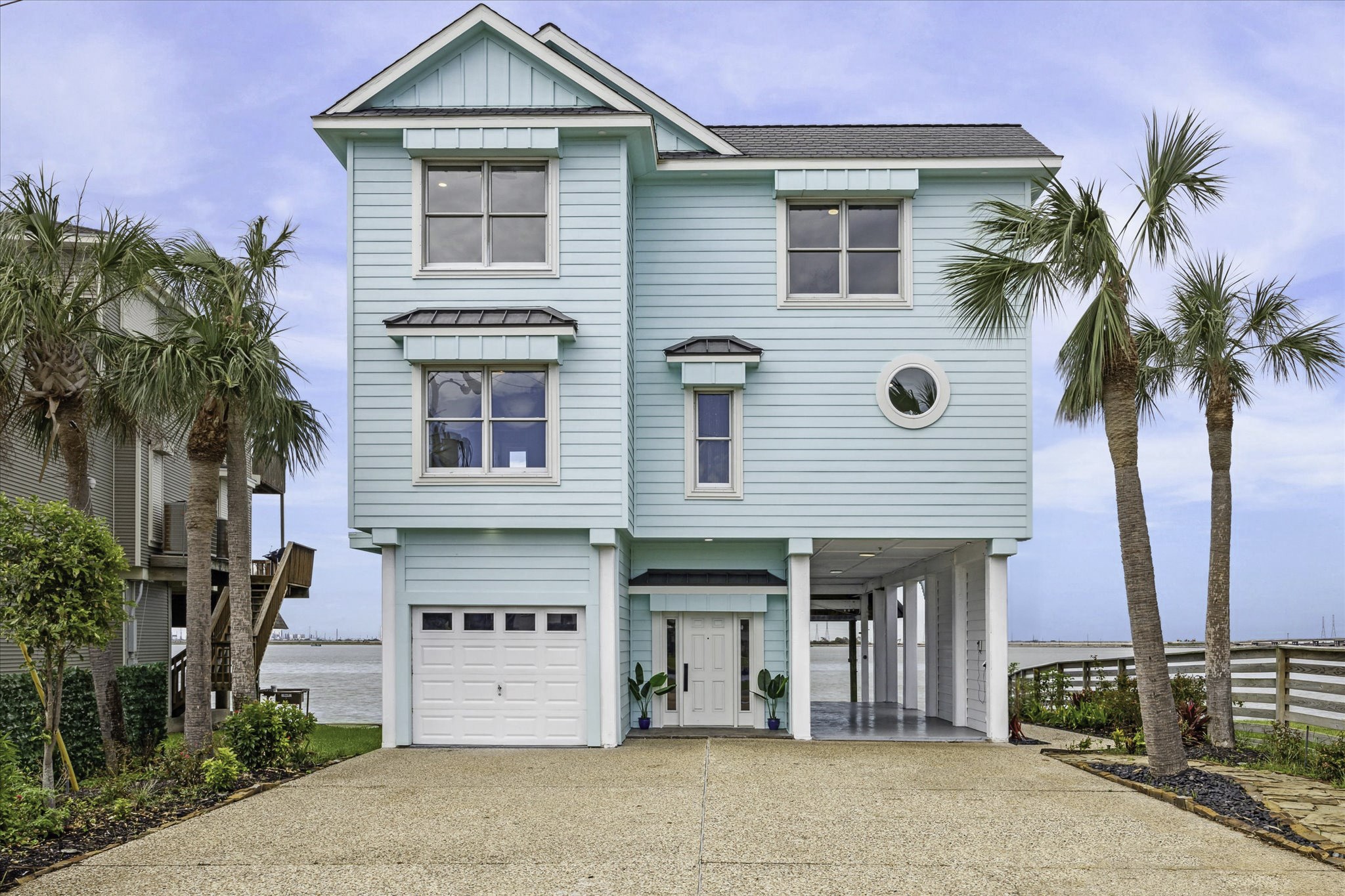 1322 Outrigger Street Tiki Island, TX 77554 - Photo 1 of 46 a front view of a house with a yard and garage