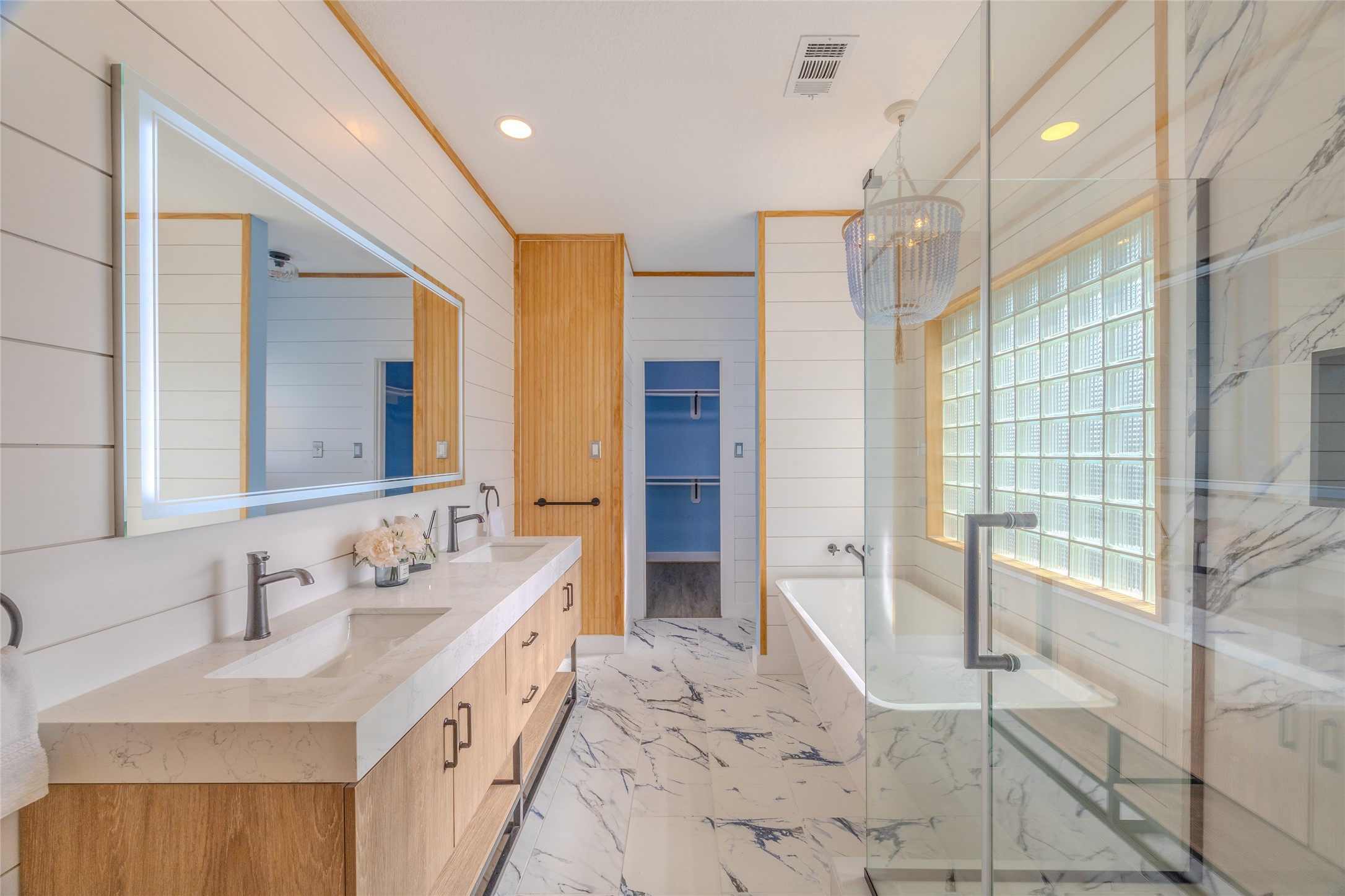 1322 Outrigger Street Tiki Island, TX 77554 - Photo 23 of 46 a spacious bathroom with a double vanity sink mirror and shower