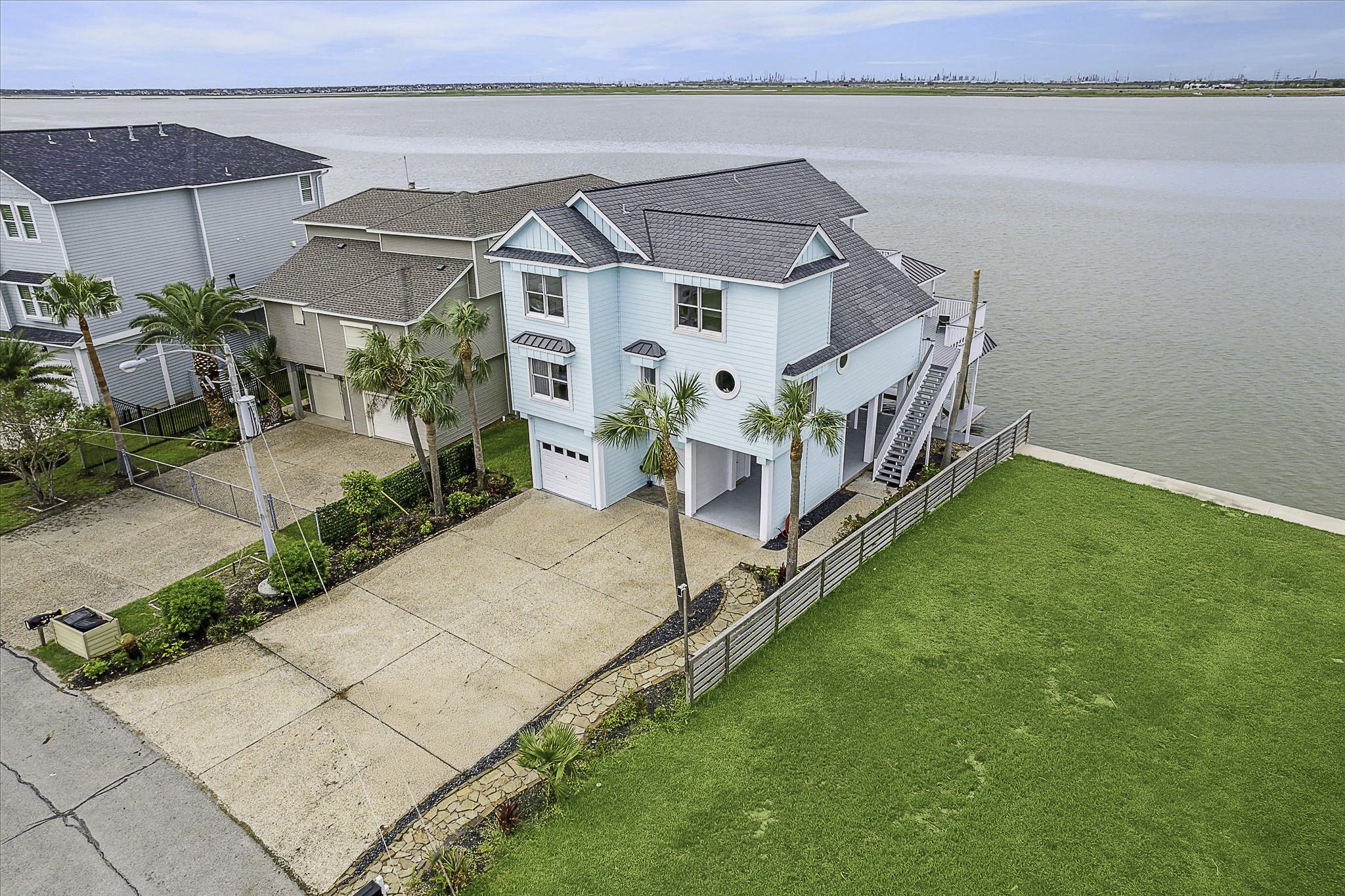 1322 Outrigger Street Tiki Island, TX 77554 - Photo 3 of 46 a view of a house with a yard and potted plants