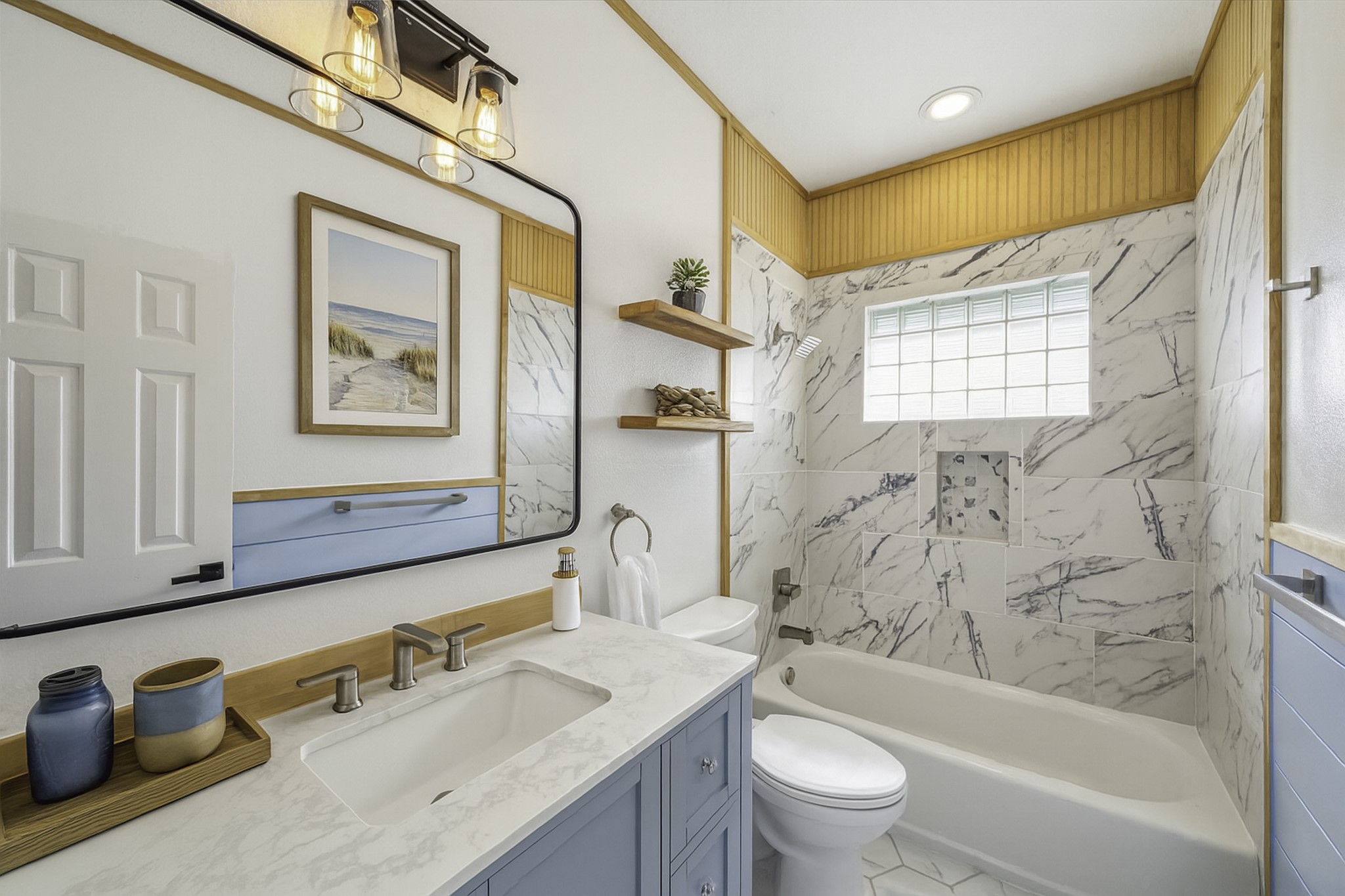 1322 Outrigger Street Tiki Island, TX 77554 - Photo 31 of 46 a bathroom with a bathtub sink mirror vanity and toilet