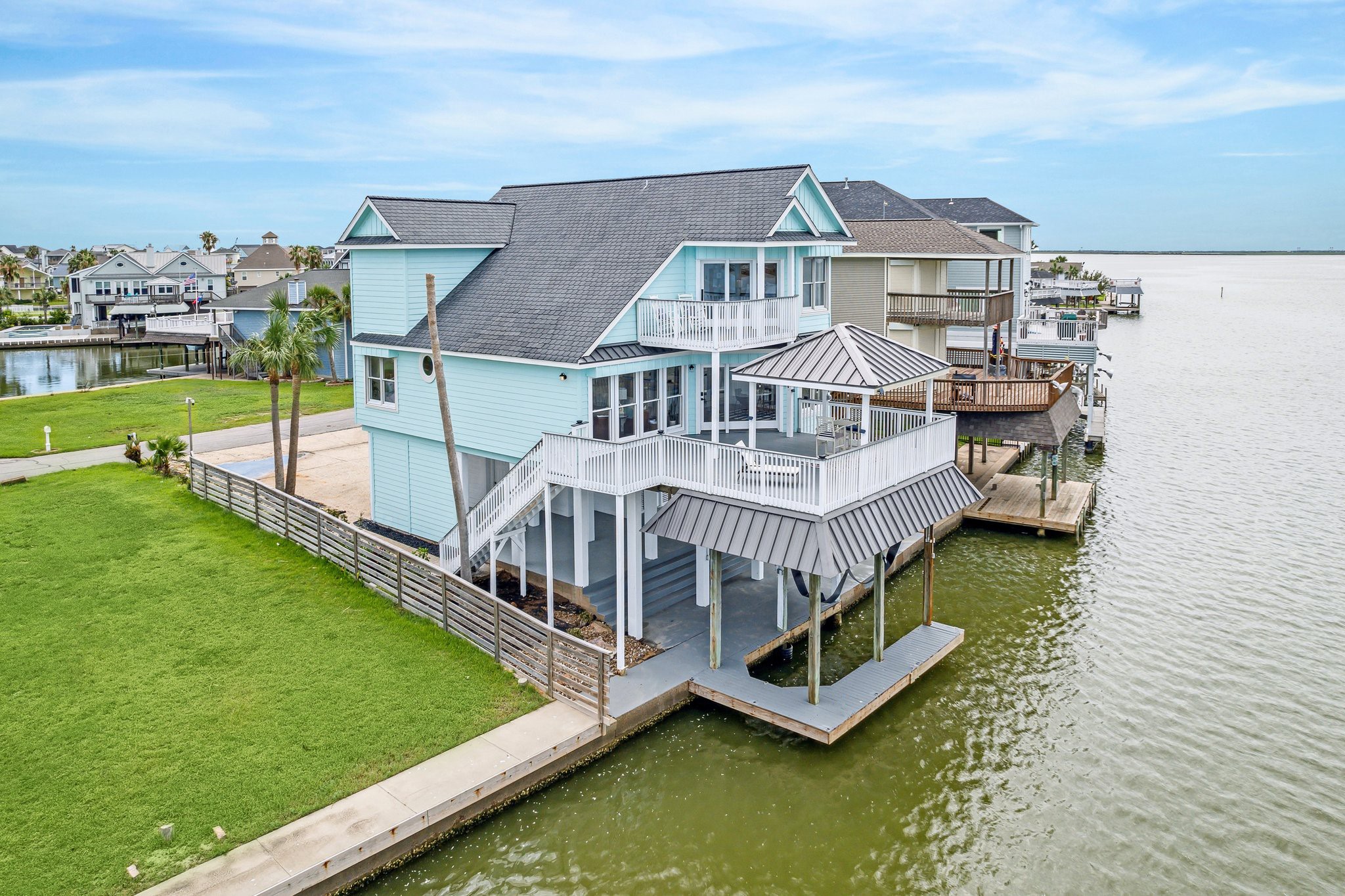 1322 Outrigger Street Tiki Island, TX 77554 - Photo 5 of 46 a view of a house with a big yard and large trees