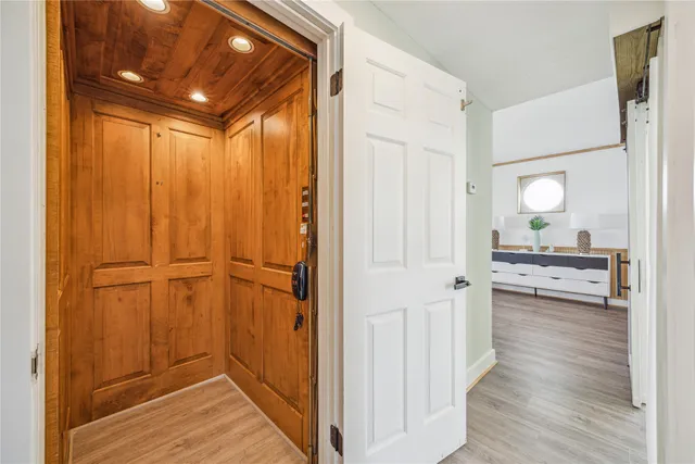 a view of a hallway with wooden floor