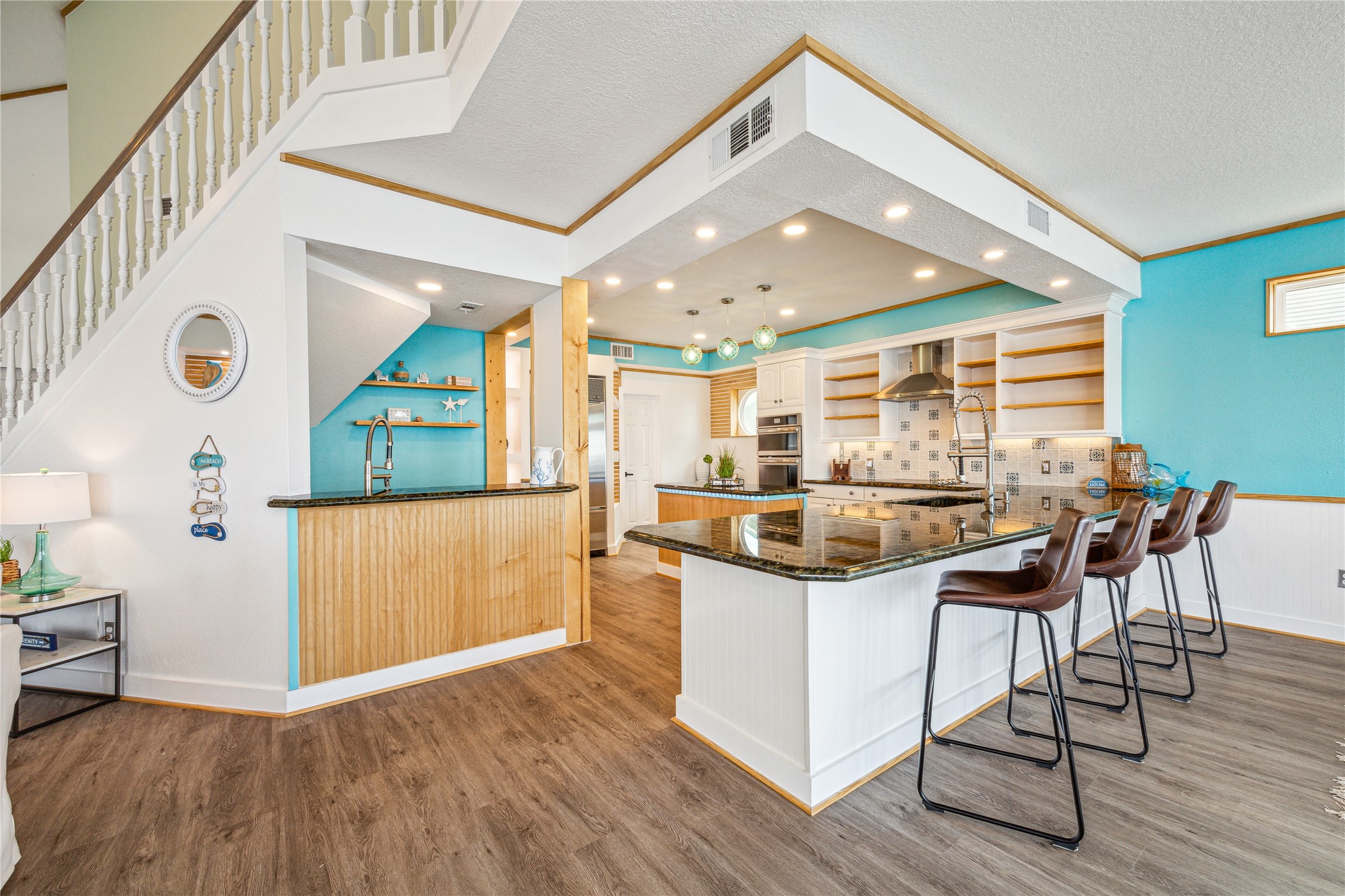 1322 Outrigger Street Tiki Island, TX 77554 - Photo 10 of 46 a kitchen with stainless steel appliances granite countertop a kitchen island a stove and a wooden floors