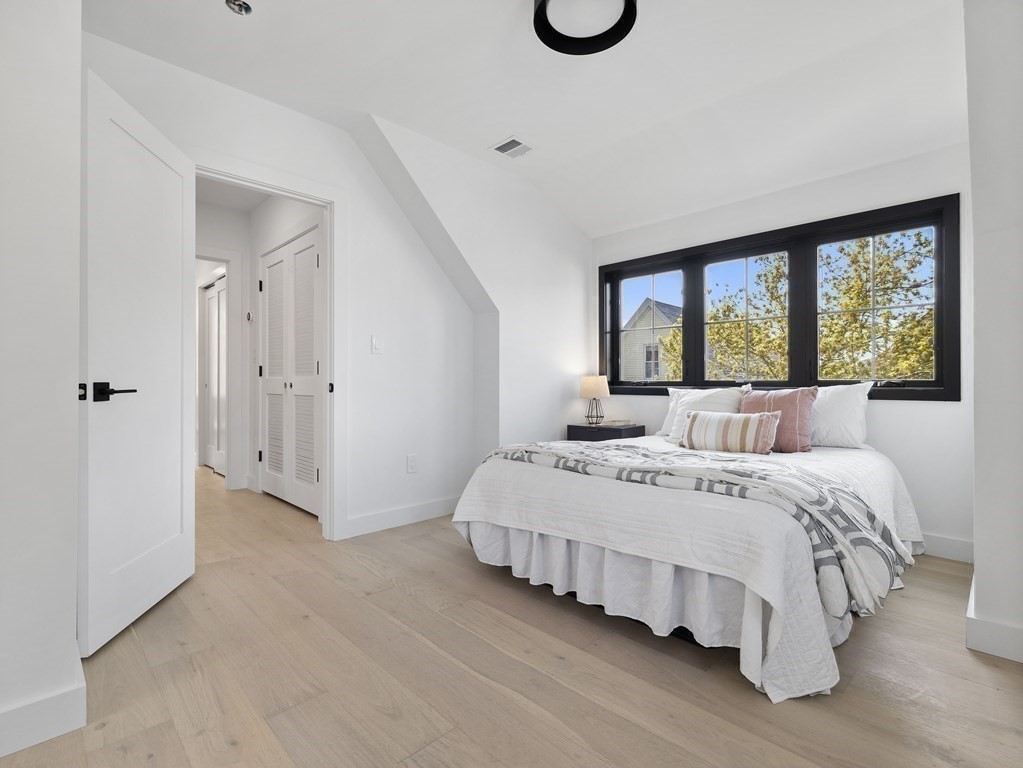 9 B Harrison Road, Unit 9B Somerville, MA 02144 - Photo 11 of 21 a bedroom with a bed and a large window