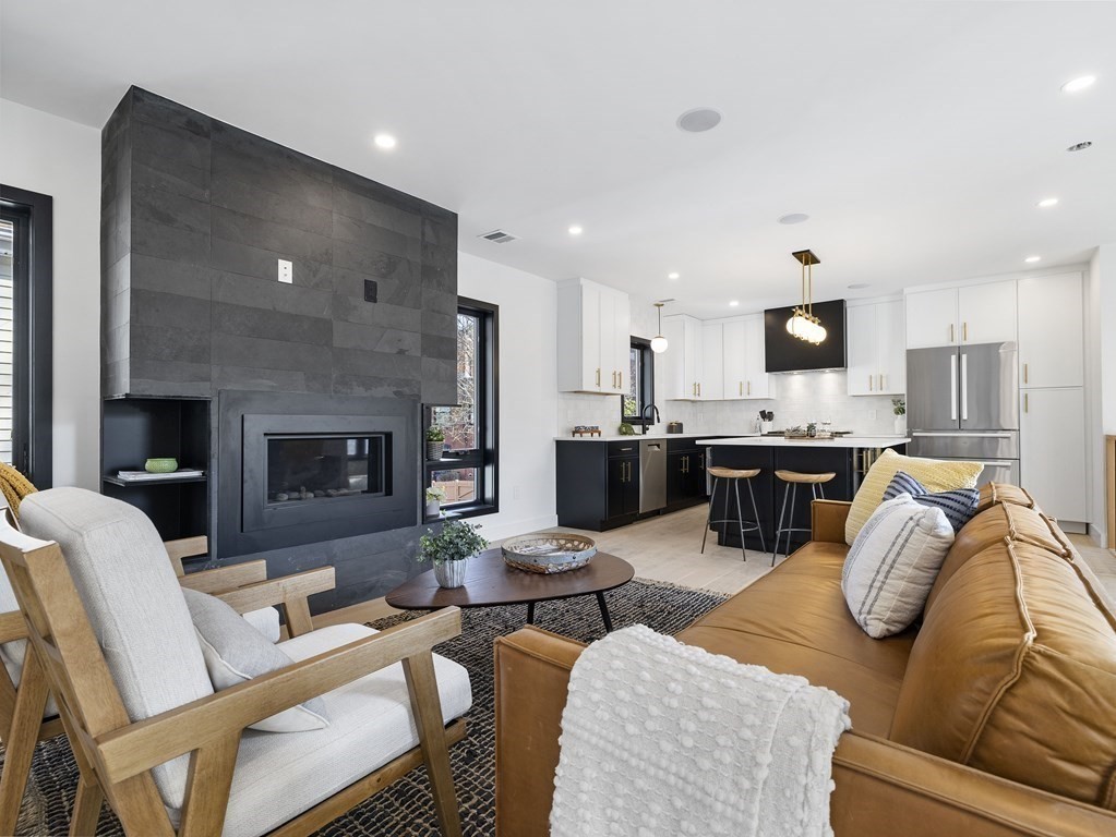 9 B Harrison Road, Unit 9B Somerville, MA 02144 - Photo 2 of 21 a living room with furniture and a fireplace