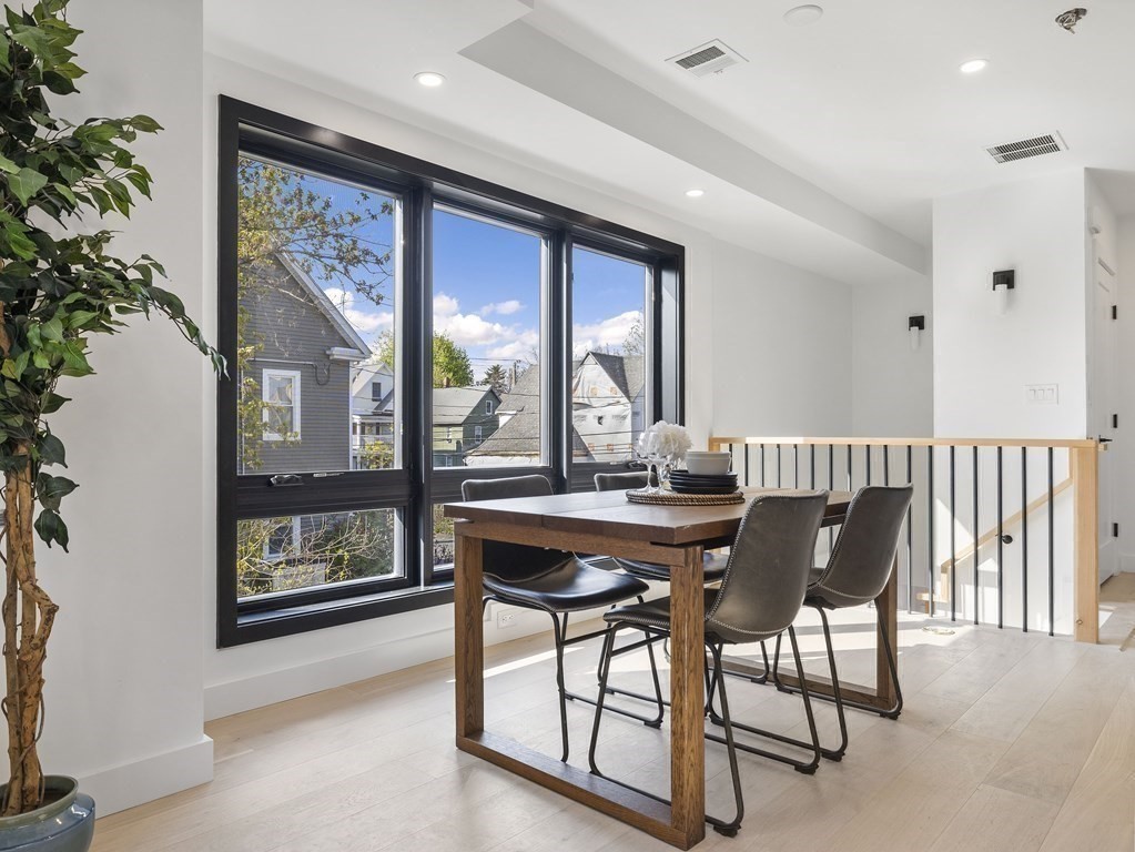 9 B Harrison Road, Unit 9B Somerville, MA 02144 - Photo 5 of 21 a view of a dining room with furniture window and wooden floor