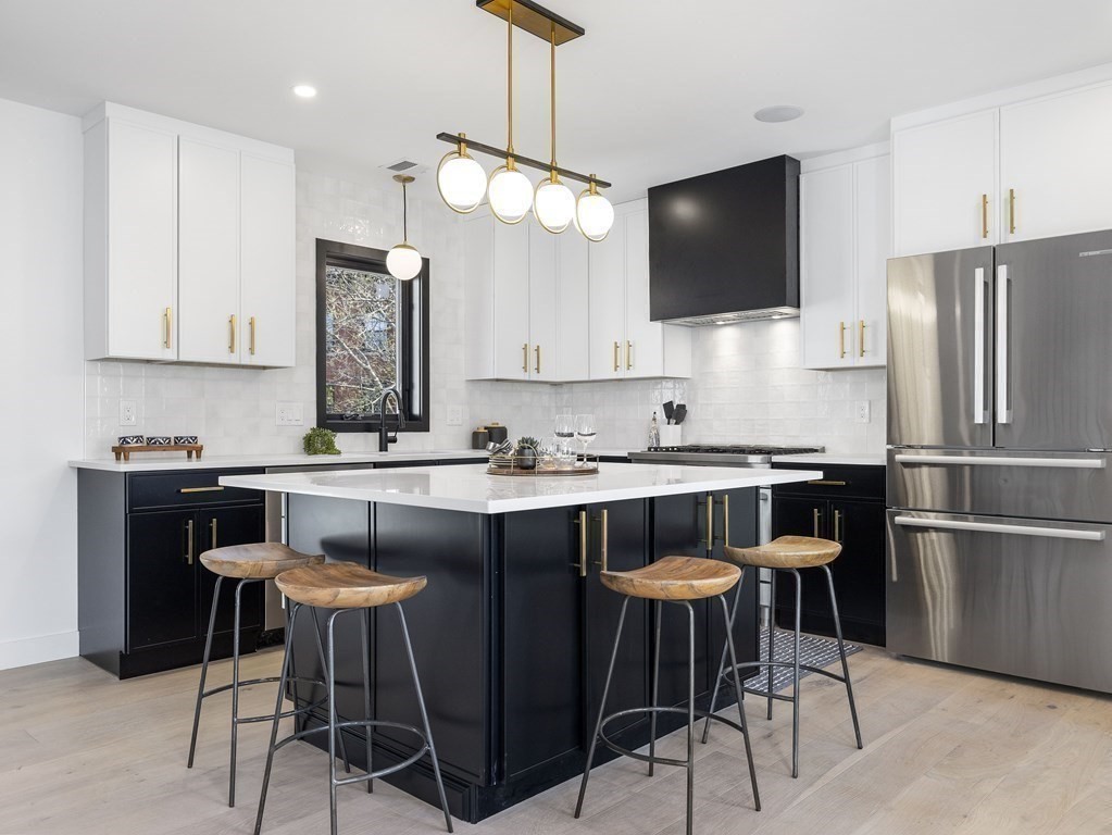 9 B Harrison Road, Unit 9B Somerville, MA 02144 - Photo 6 of 21 a kitchen with a dining table chairs stainless steel appliances and cabinets