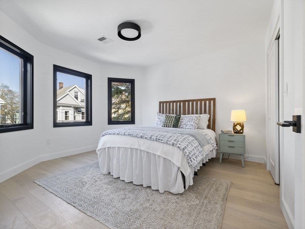 9 B Harrison Road, Unit 9B Somerville, MA 02144 - Photo 8 of 21 a bedroom with a bed and painting on the wall