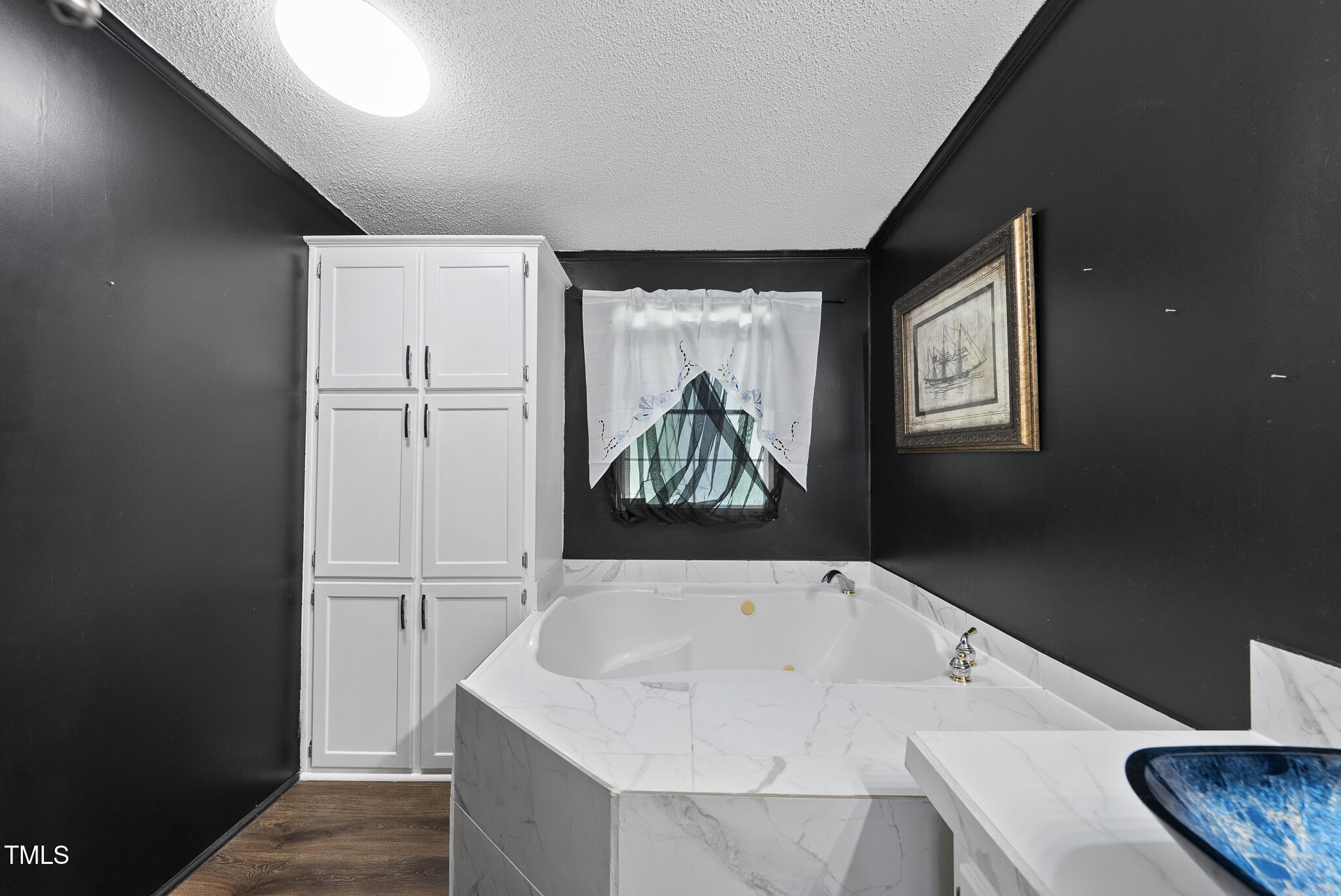 186 Saplin Branch Road Timberlake, NC 27583 - Photo 18 of 46 a bathroom with a bathtub and a window