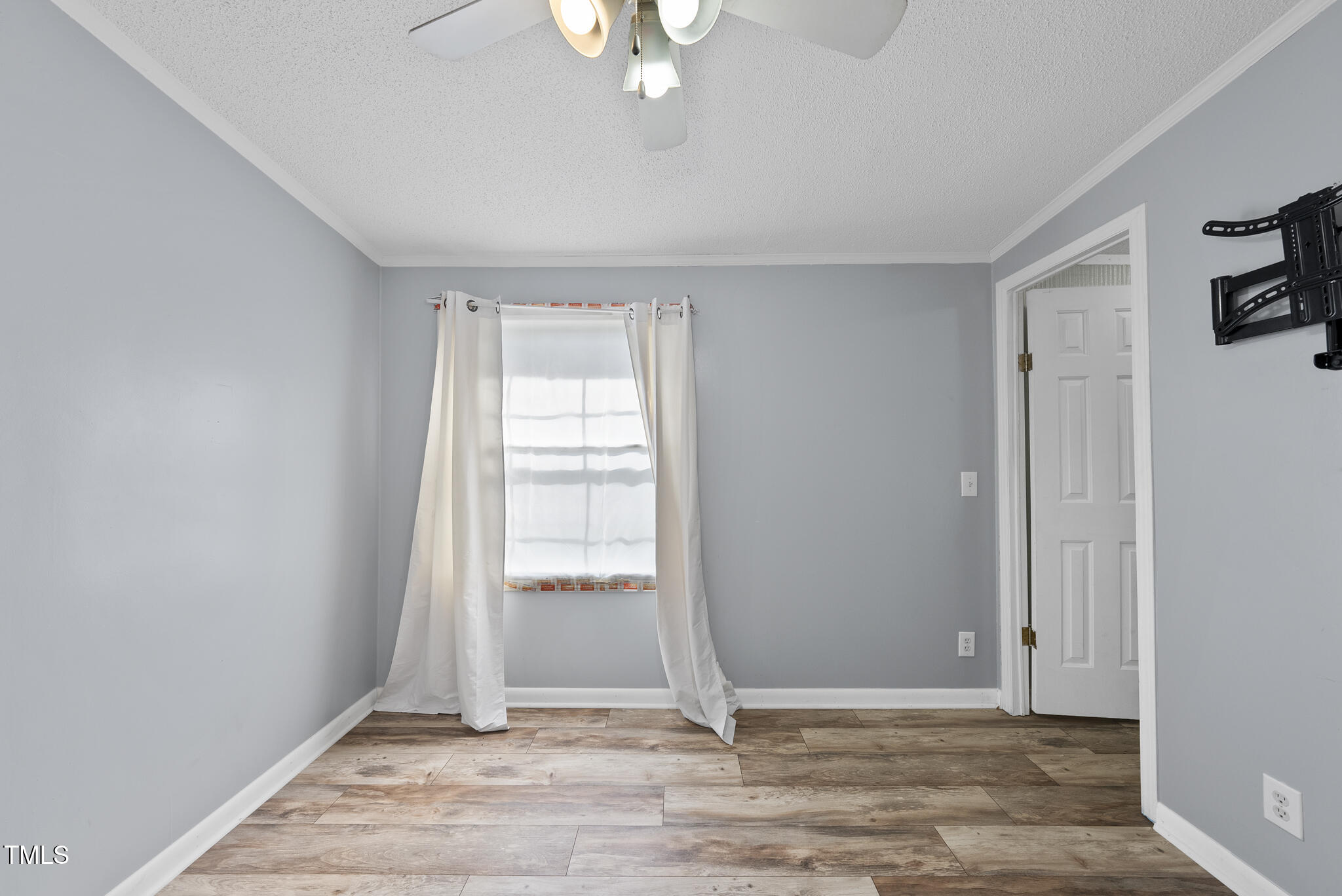 186 Saplin Branch Road Timberlake, NC 27583 - Photo 23 of 46 an empty room with wooden floor cabinet and windows