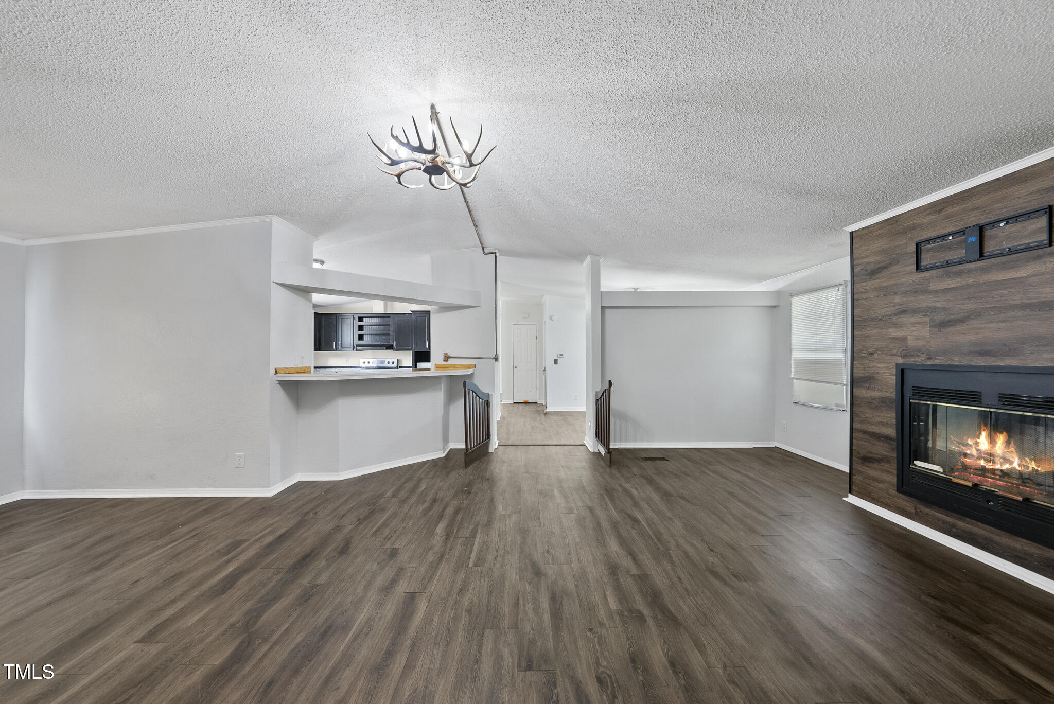 186 Saplin Branch Road Timberlake, NC 27583 - Photo 3 of 46 a view of empty room with wooden floor fireplace and window
