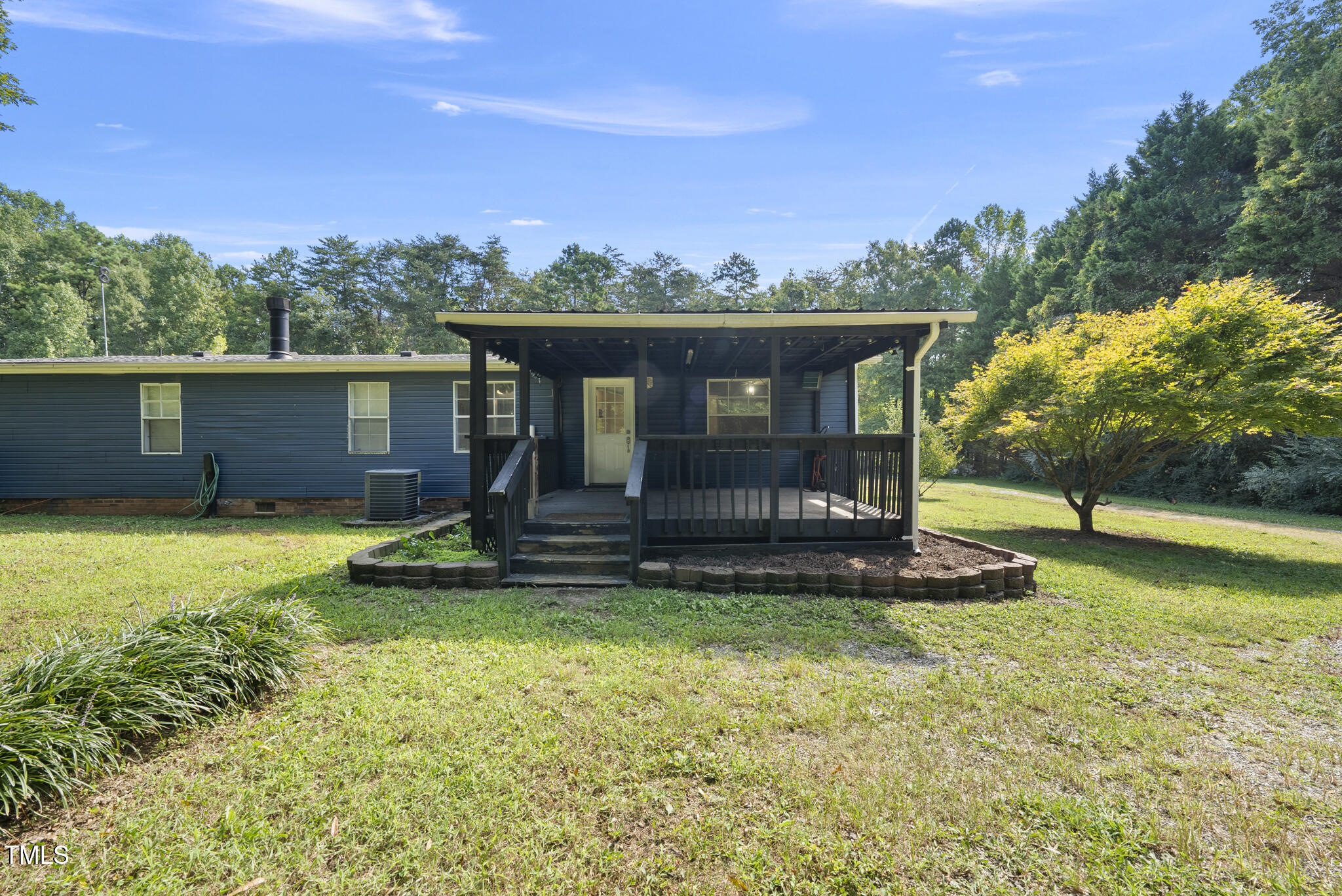186 Saplin Branch Road Timberlake, NC 27583 - Photo 32 of 46 a view of a garden with a bench