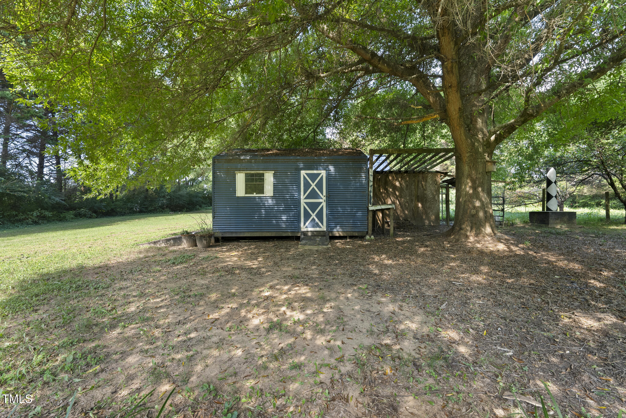 186 Saplin Branch Road Timberlake, NC 27583 - Photo 34 of 46 a view of a barn in the middle of a yard
