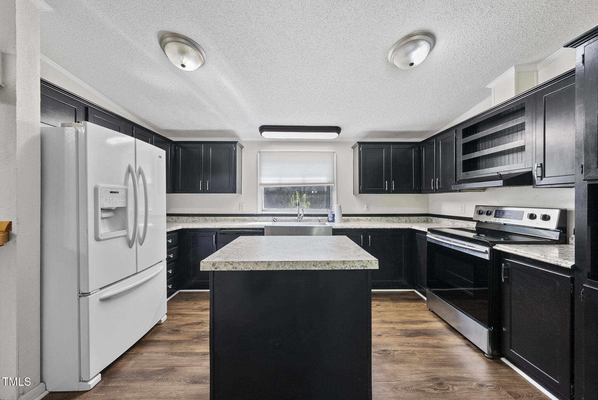 186 Saplin Branch Road Timberlake, NC 27583 - Photo 4 of 46 a kitchen with stainless steel appliances granite countertop a refrigerator a sink dishwasher a stove top oven a refrigerator with island and cabinets