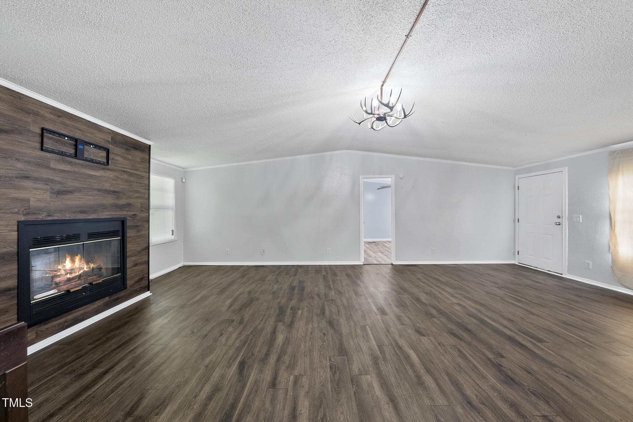 186 Saplin Branch Road Timberlake, NC 27583 - Photo 6 of 46 a view of empty room with wooden floor and fireplace