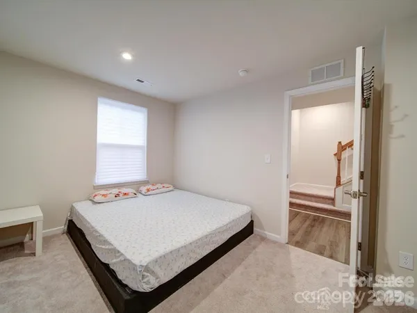 a bedroom with a bed and dresser