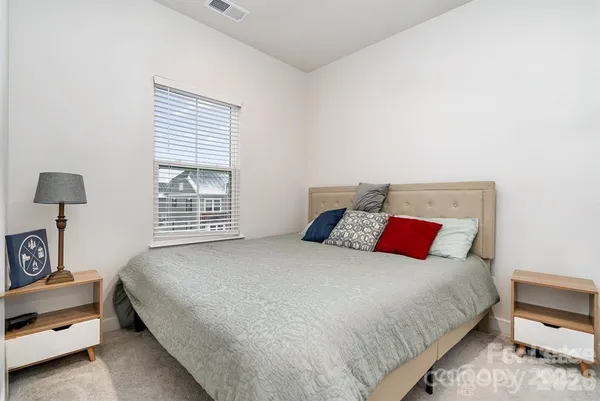 a bedroom with a bed and a night stand