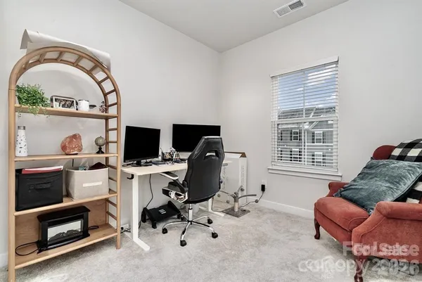 a livingroom with workspace and a window