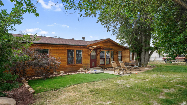 490 South Main Street Kamas, UT 84036 - Photo 3 of 25 Wood-sided exterior featuring multiple windows and a covered entrance