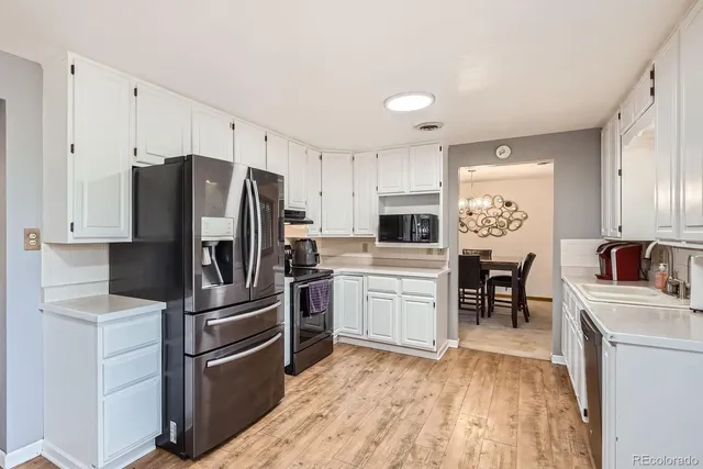 a kitchen with stainless steel appliances a refrigerator sink and microwave