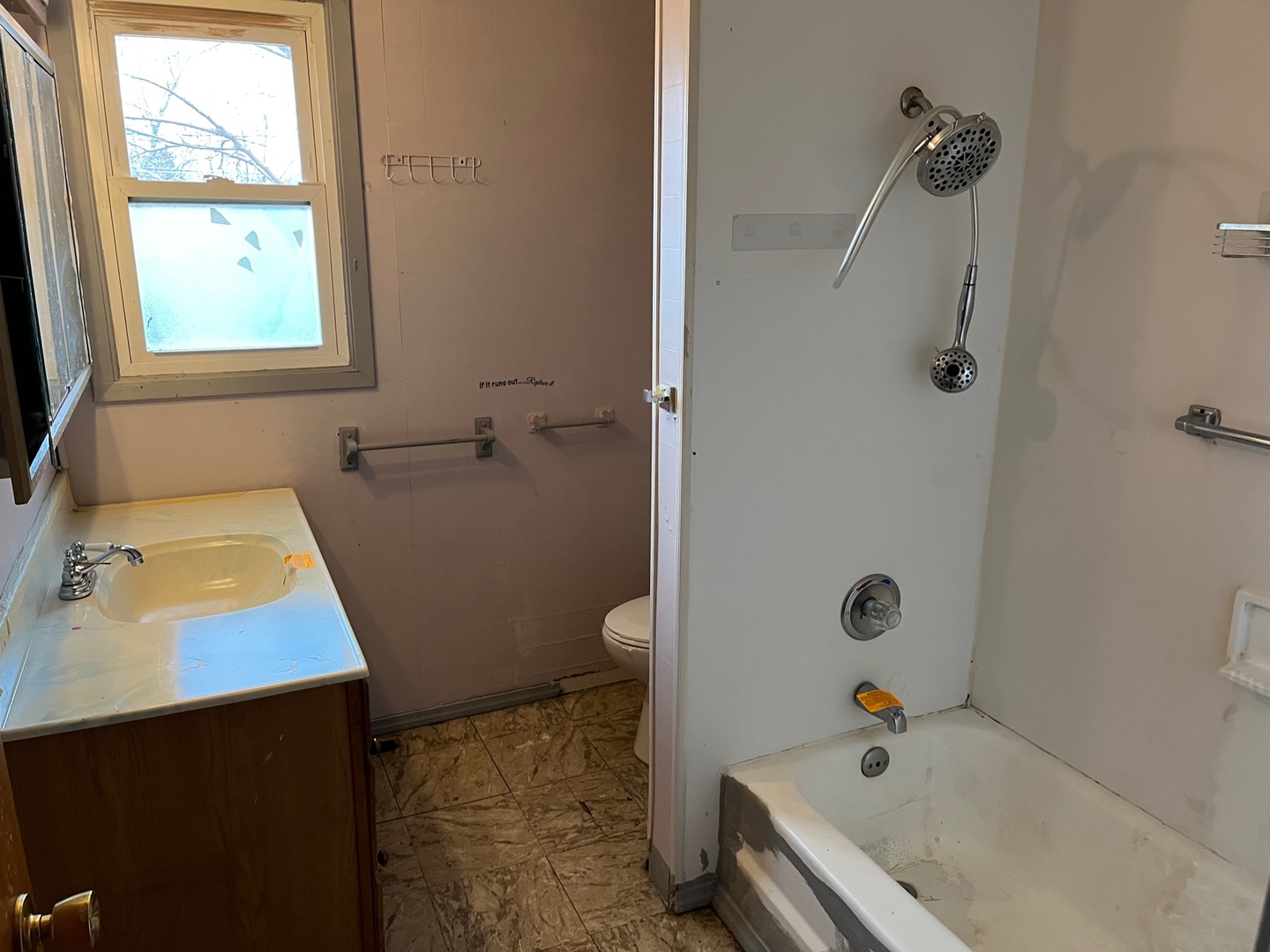 709 Kathleen Drive Normal, IL 61761 - Photo 17 of 32 a bathroom with a tub a sink a window and shower