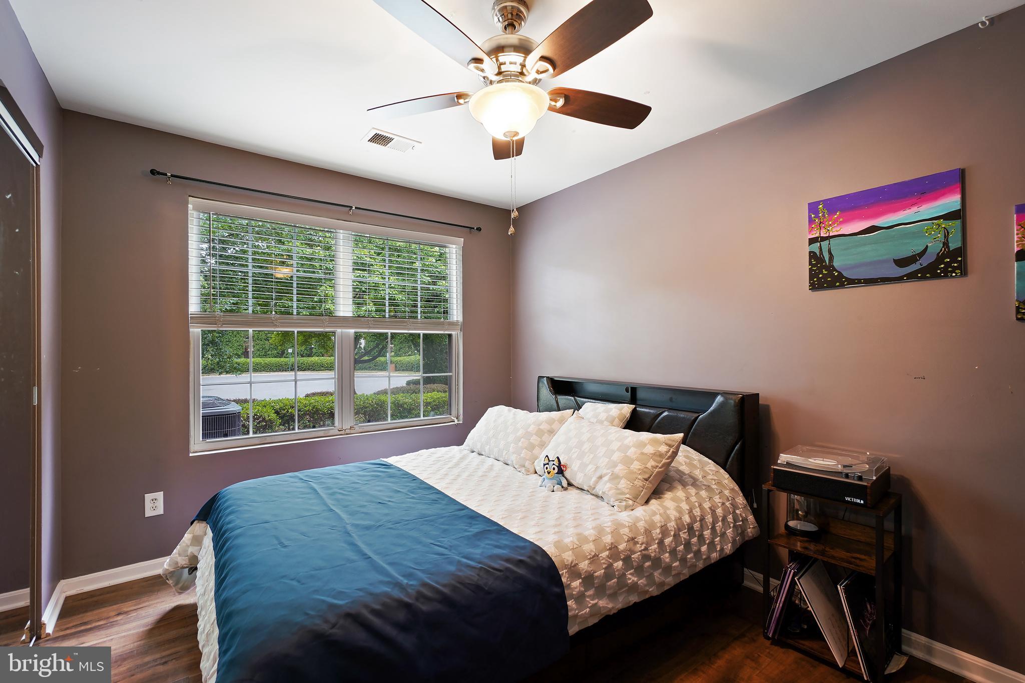 14151 Cuddy Loop, Unit 101 Woodbridge, VA 22193 - Photo 16 of 45 a bedroom with a bed and a flat screen tv