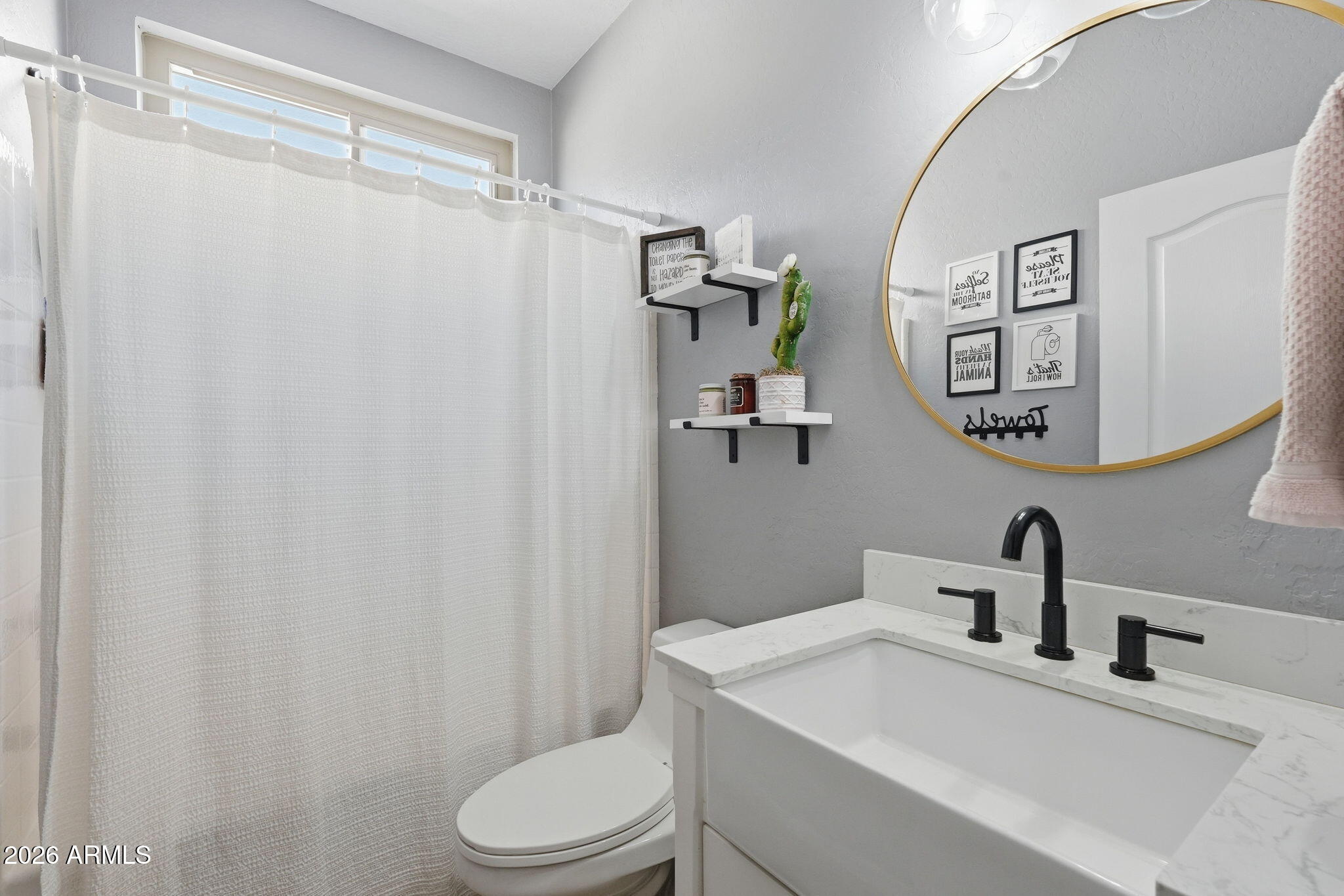 4184 East Trigger Way Gilbert, AZ 85297 - Photo 20 of 51 a bathroom with a sink vanity mirror and toilet
