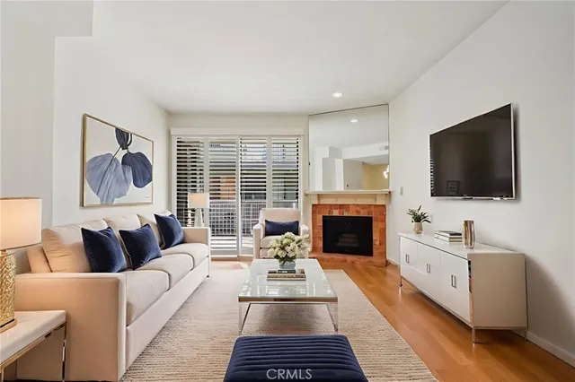 a living room with furniture fireplace and flat screen tv
