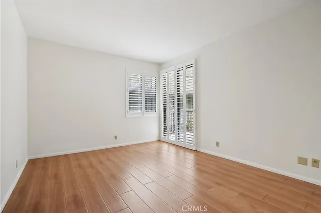 a view of a hallway with closet and a window