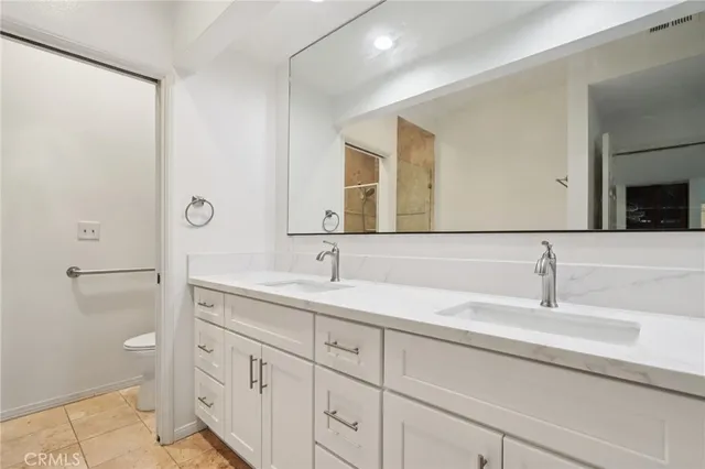 a bathroom with a double vanity sink and mirror