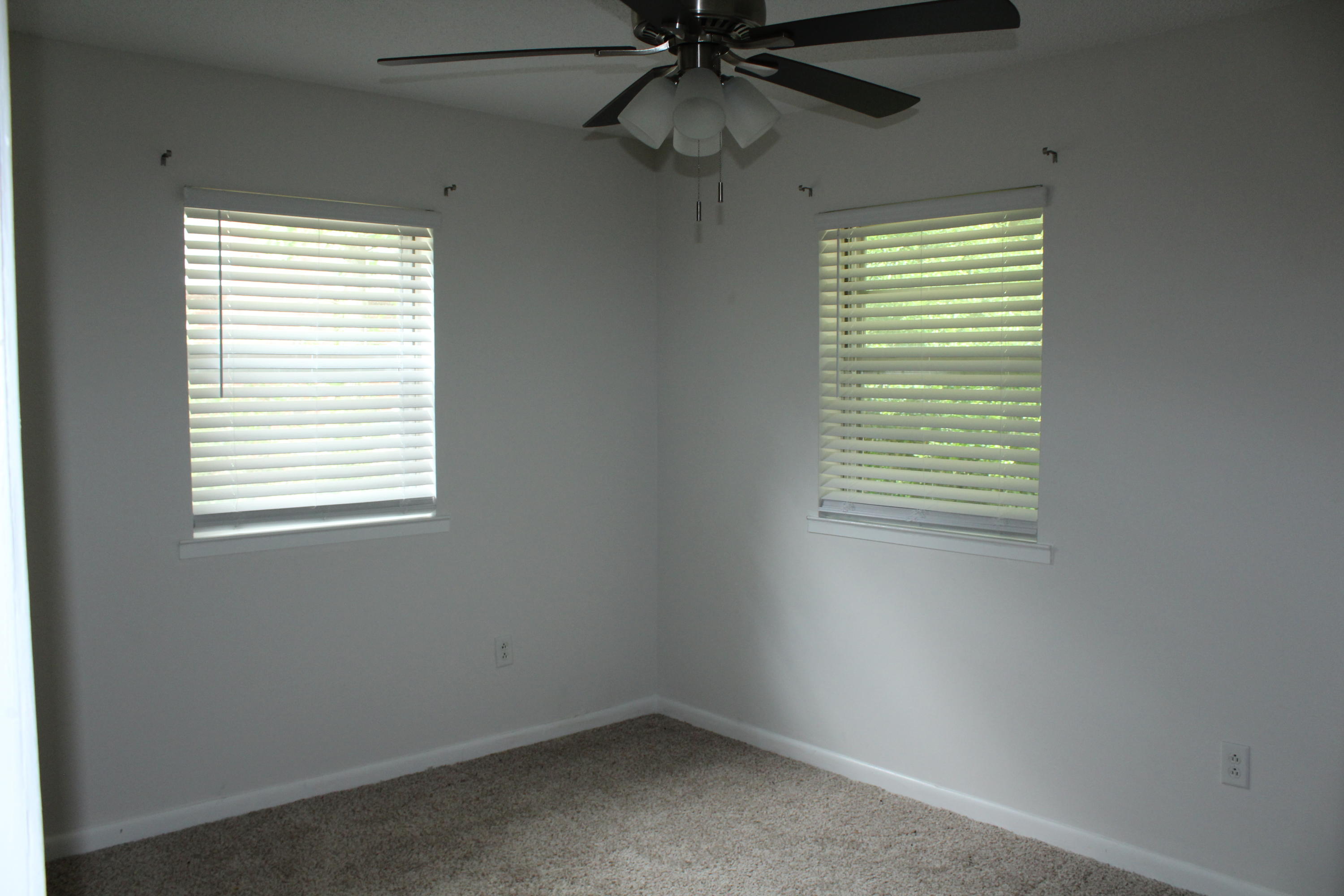 313 Brackin Street, Unit A Crestview, FL 32539 - Photo 16 of 27 an empty room with a window and a fan