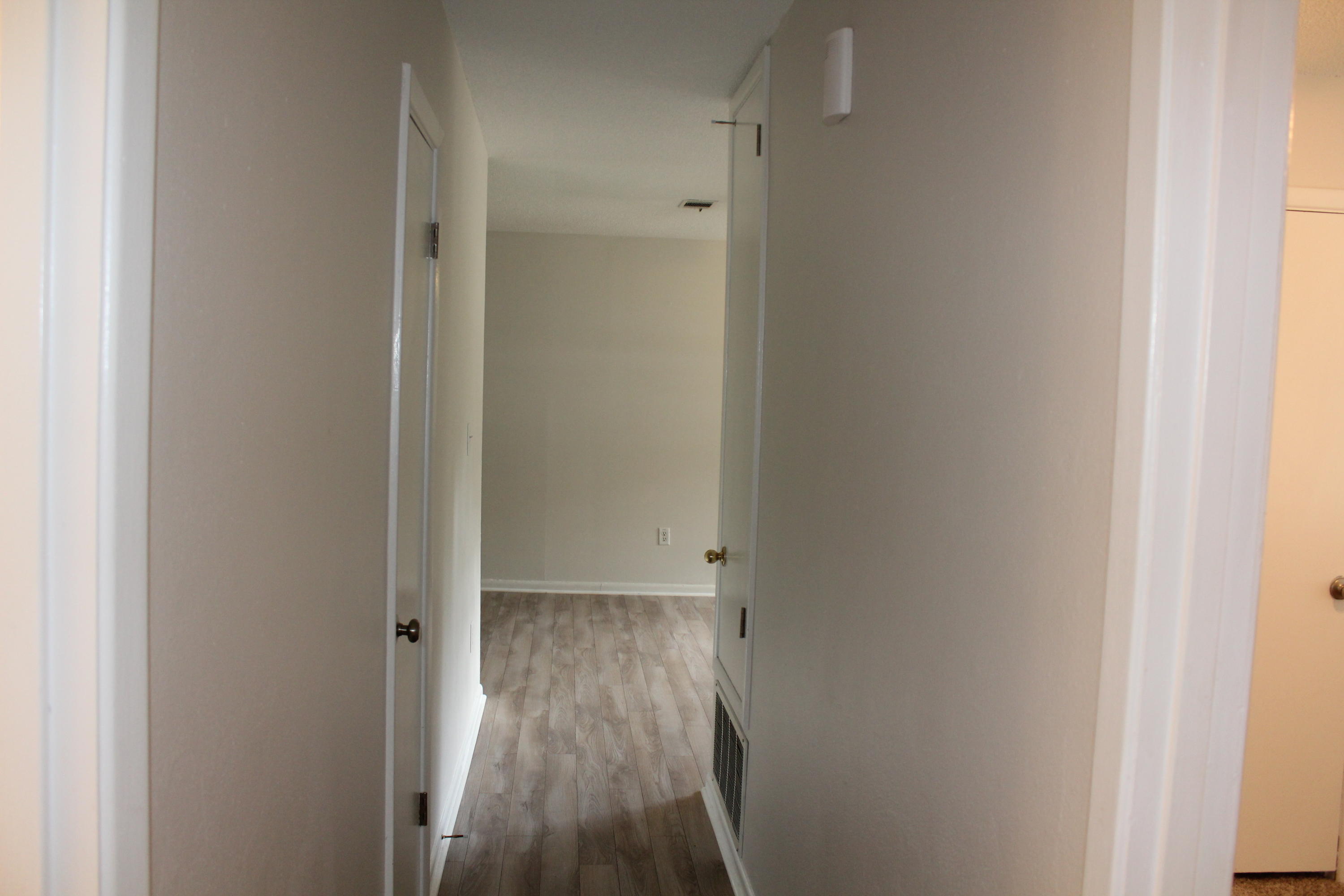 313 Brackin Street, Unit A Crestview, FL 32539 - Photo 18 of 27 a view of a hallway with wooden floor