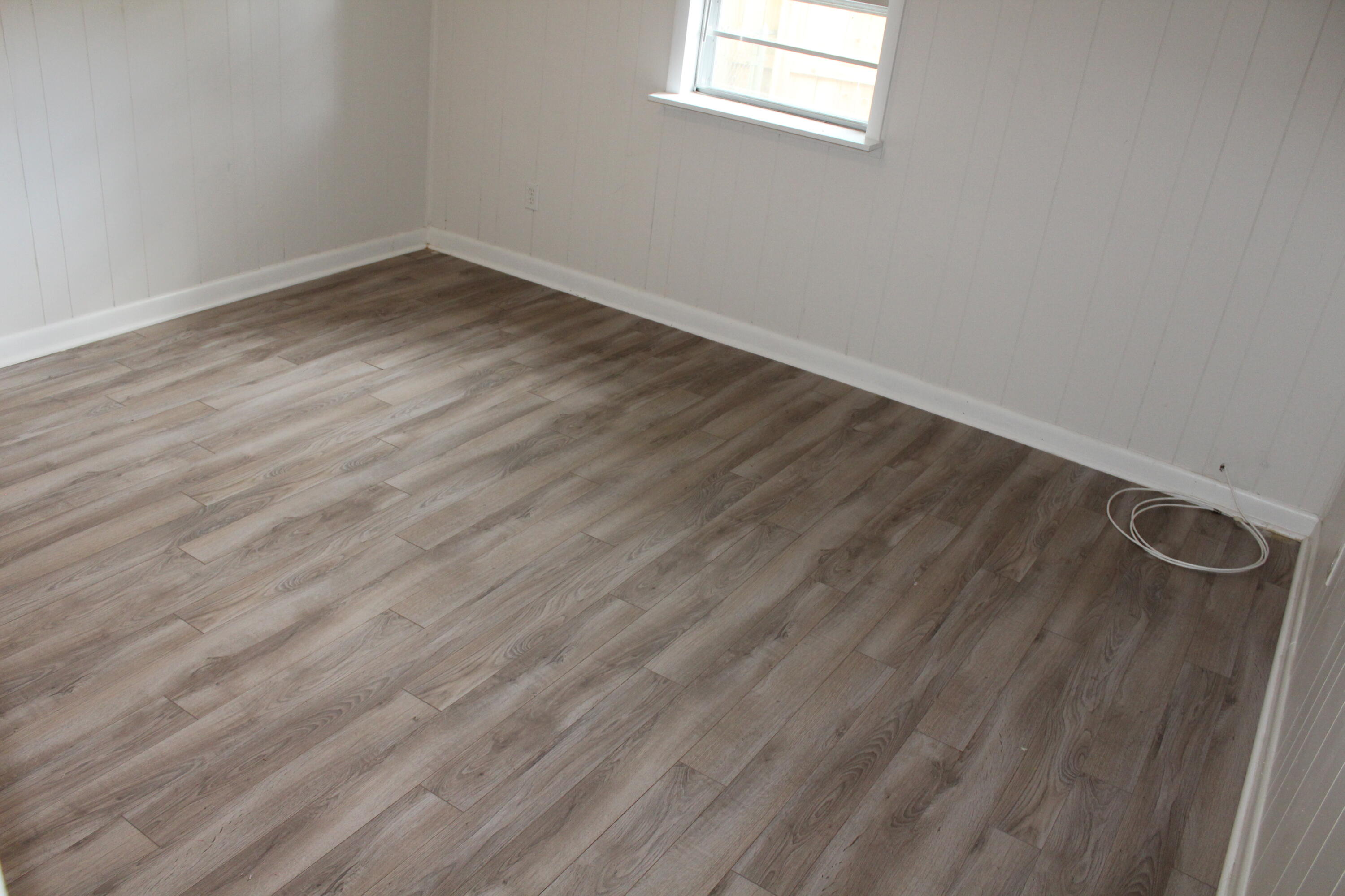 313 Brackin Street, Unit A Crestview, FL 32539 - Photo 19 of 27 a view of a room with wooden floor and window