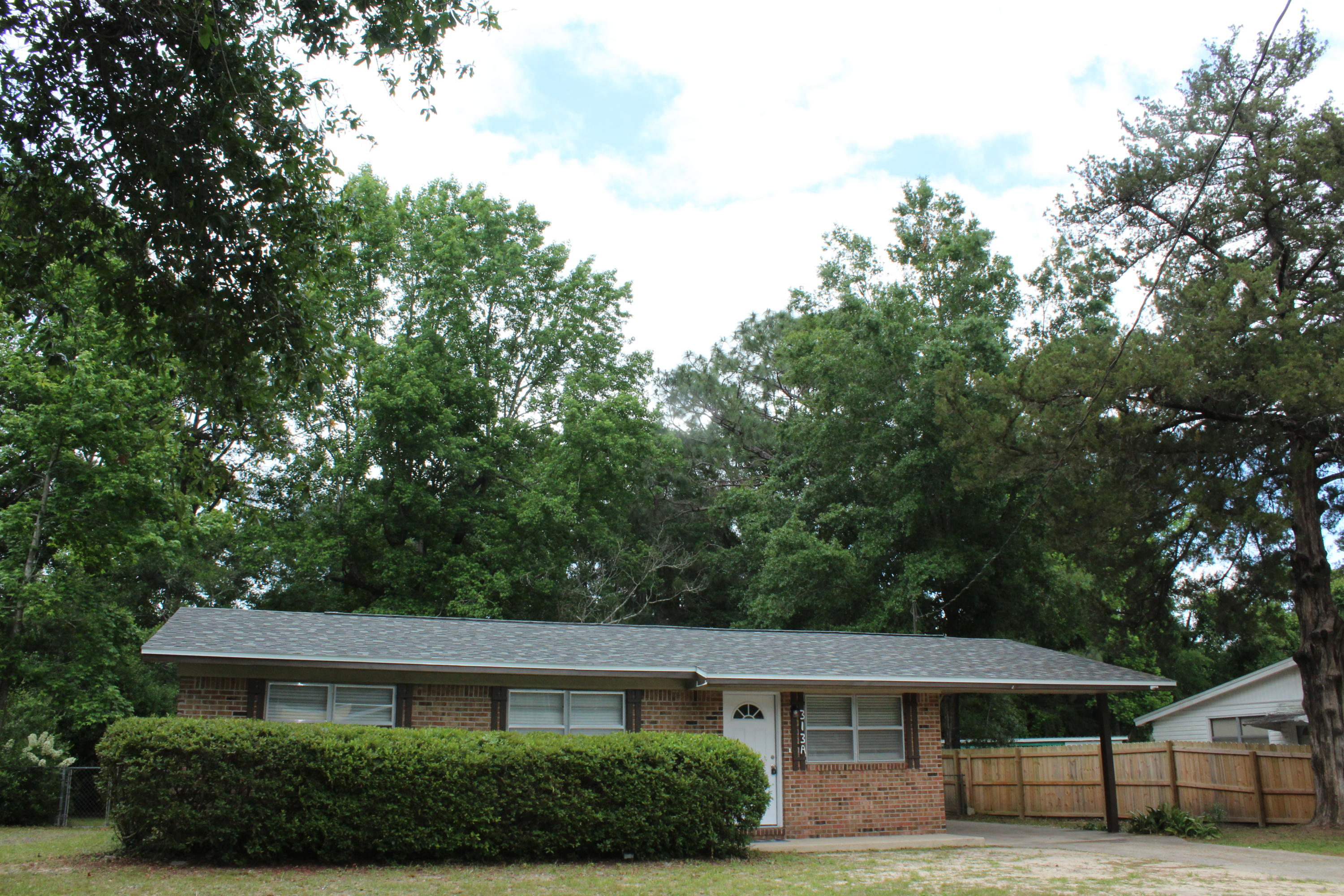 313 Brackin Street, Unit A Crestview, FL 32539 - Photo 2 of 27 a front view of a house with a yard