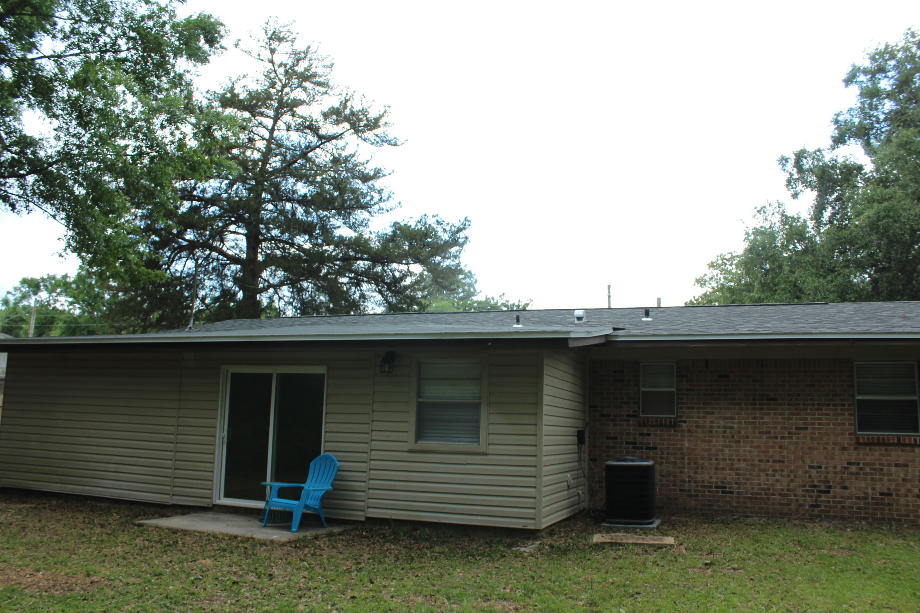 313 Brackin Street, Unit A Crestview, FL 32539 - Photo 24 of 27 a backyard of a house with lots of green space