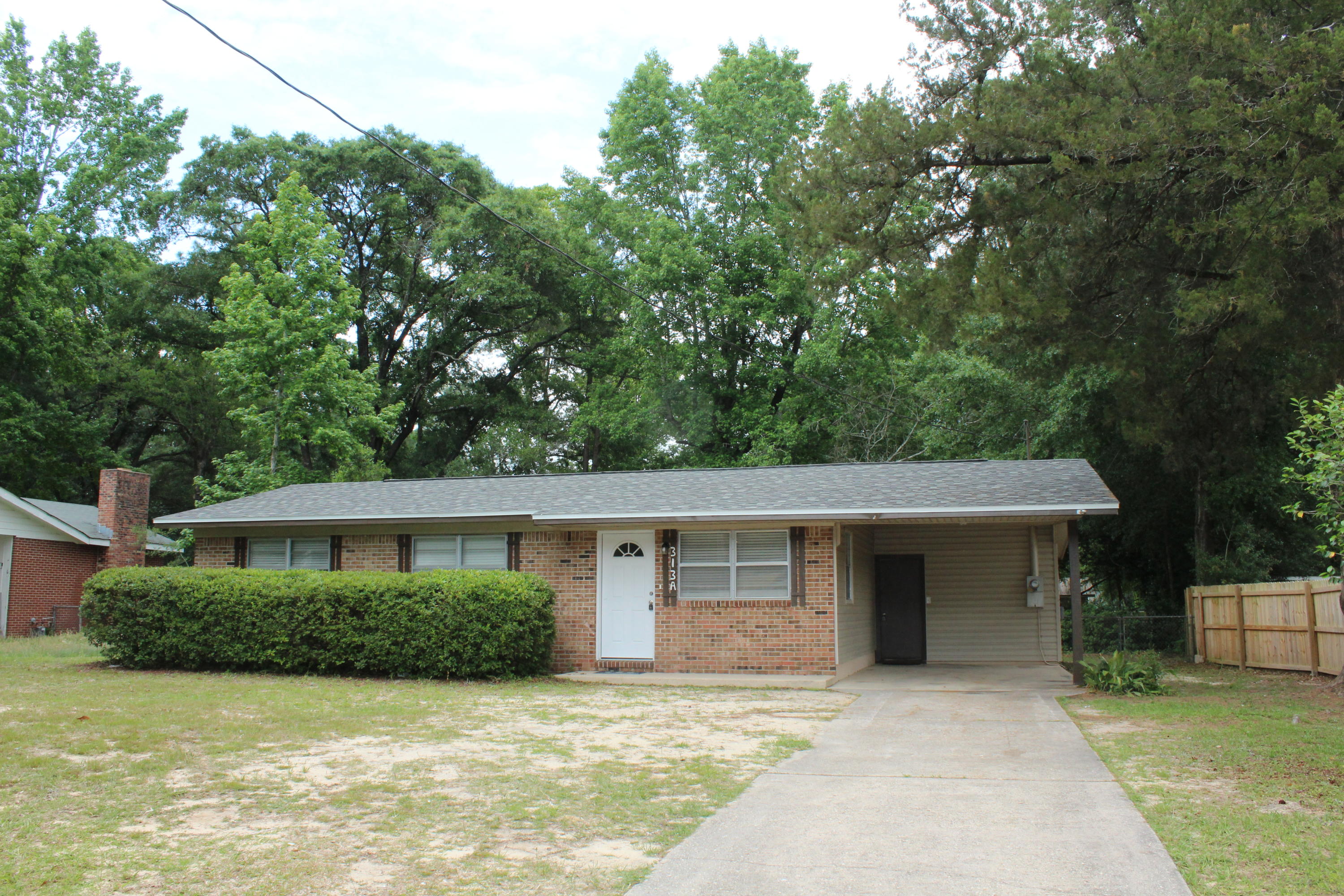 313 Brackin Street, Unit A Crestview, FL 32539 - Photo 26 of 27 front view of a house with a patio