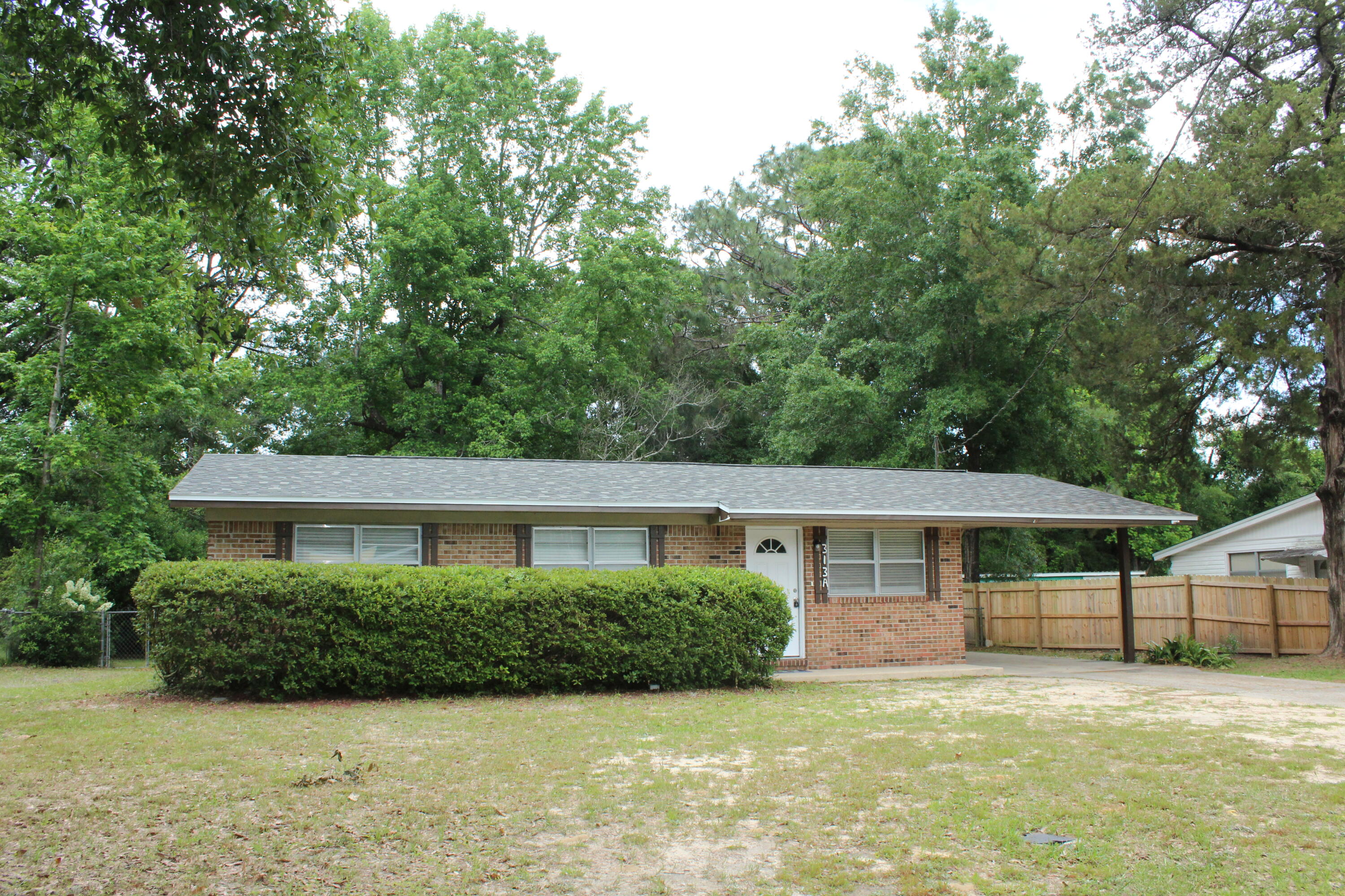 313 Brackin Street, Unit A Crestview, FL 32539 - Photo 27 of 27 a front view of a house with a garden and porch