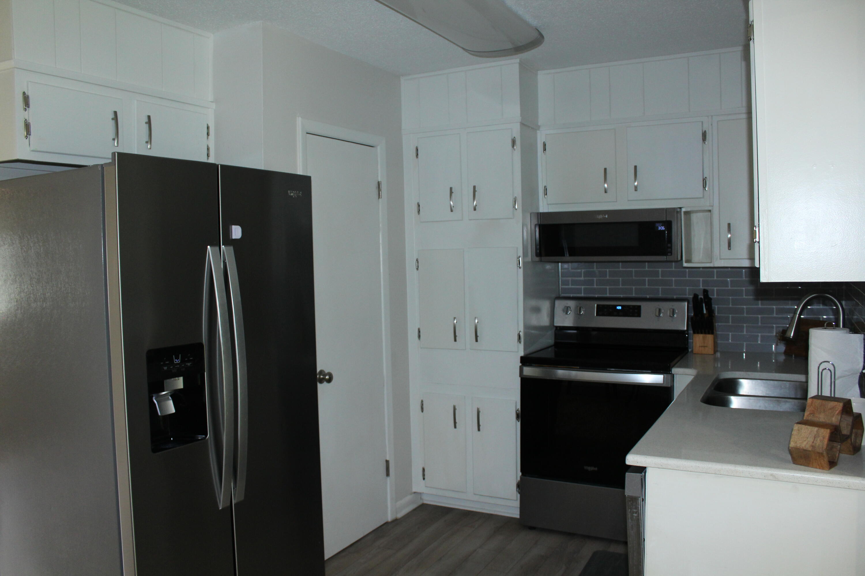 313 Brackin Street, Unit A Crestview, FL 32539 - Photo 6 of 27 a kitchen with a refrigerator and a stove top oven