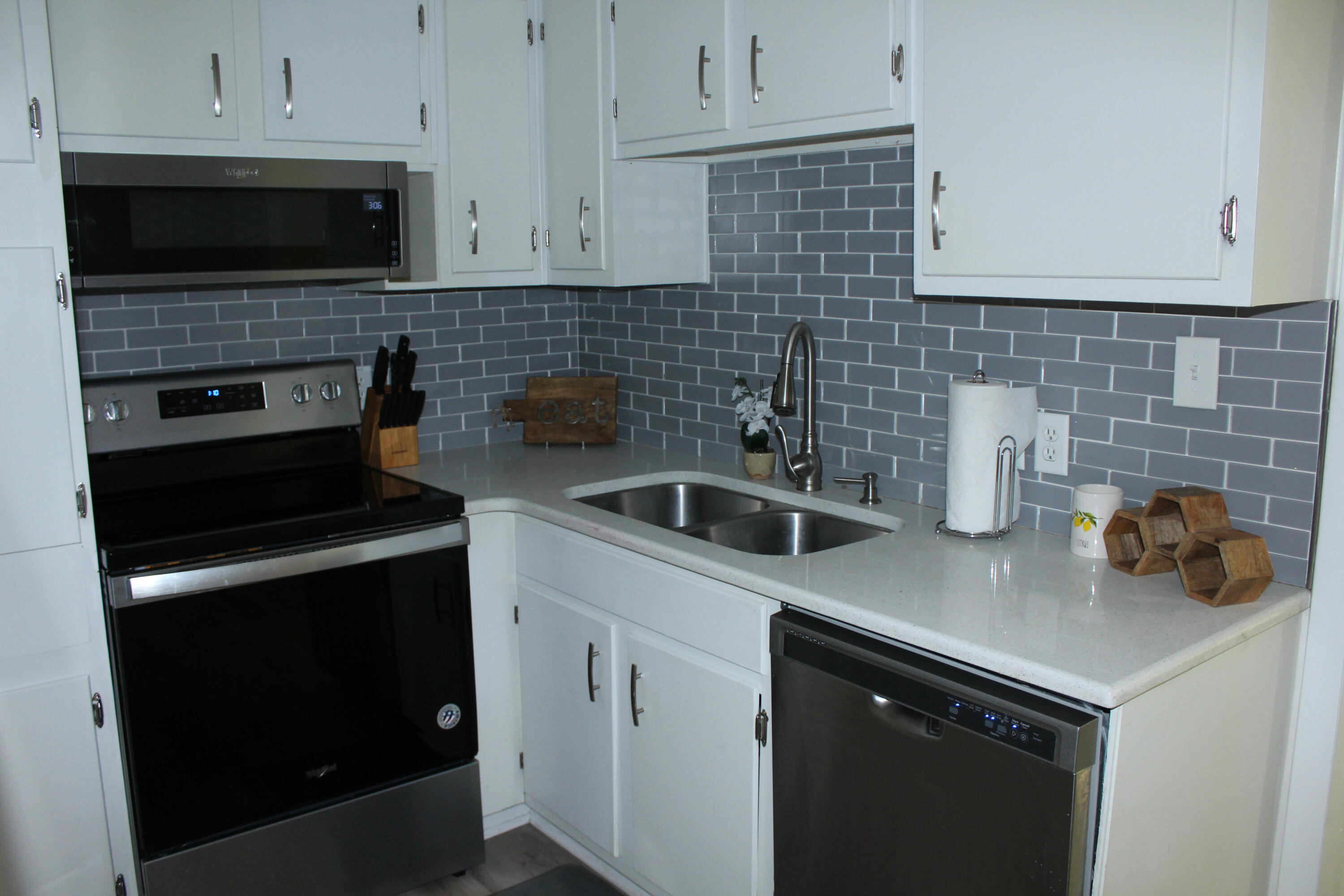 313 Brackin Street, Unit A Crestview, FL 32539 - Photo 7 of 27 a kitchen with a sink and cabinets appliances