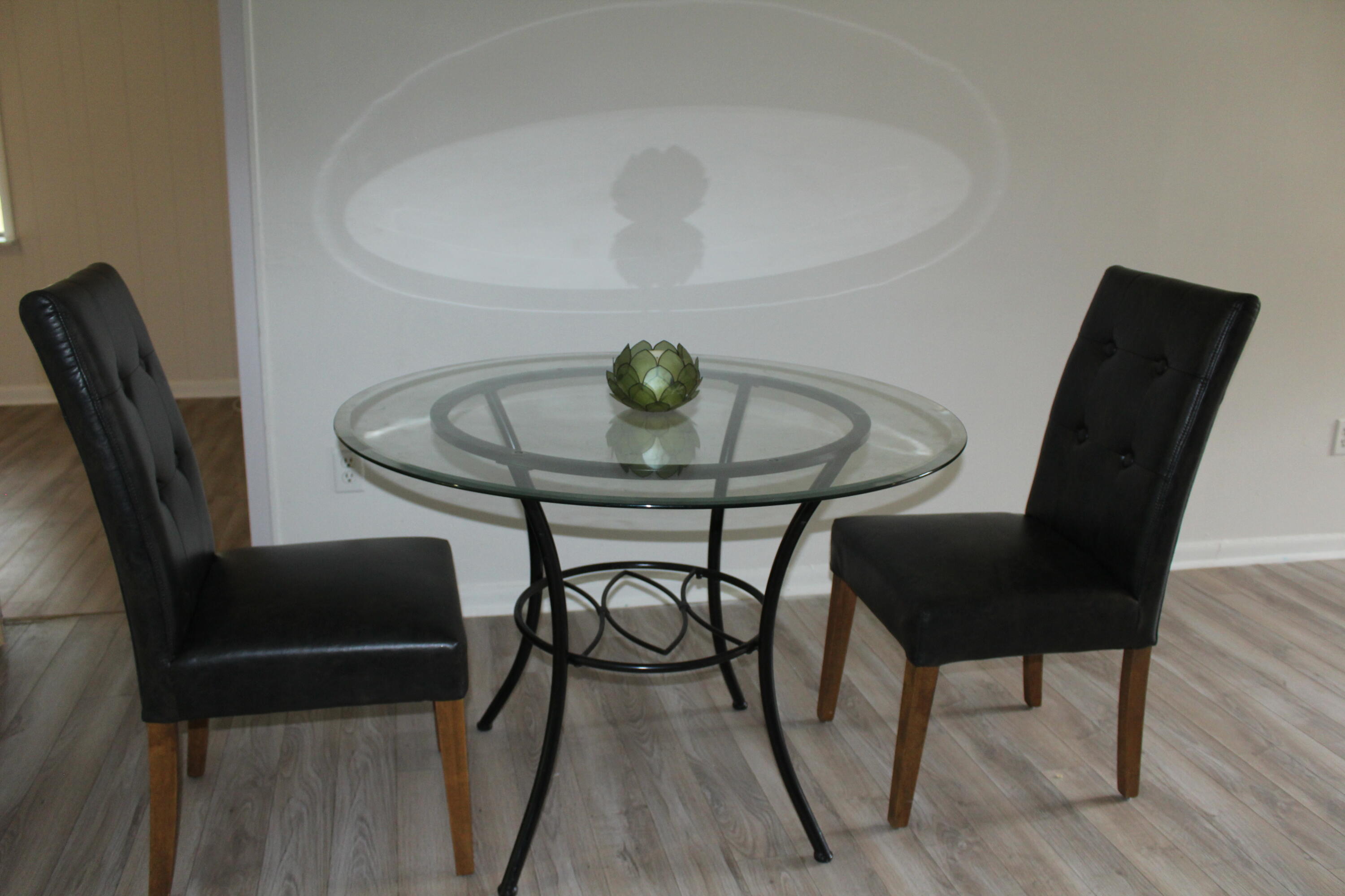 313 Brackin Street, Unit A Crestview, FL 32539 - Photo 9 of 27 a view of a dining room with furniture and wooden floor