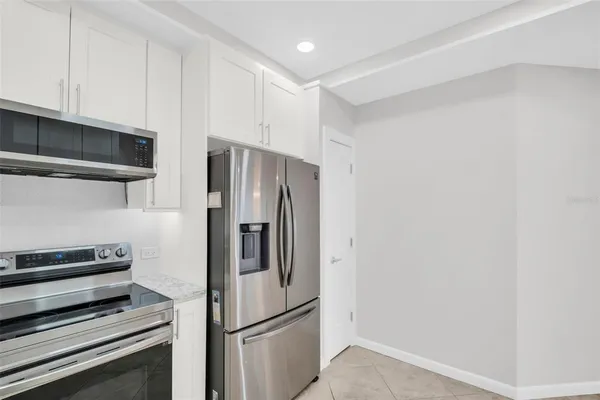 a metallic refrigerator freezer sitting in a kitchen