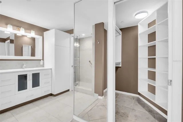 a view of bathroom with a shower and a sink