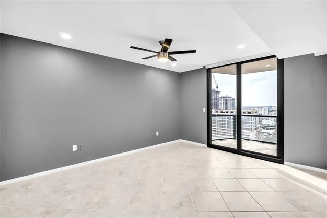 a view of an empty room and a ceiling fan