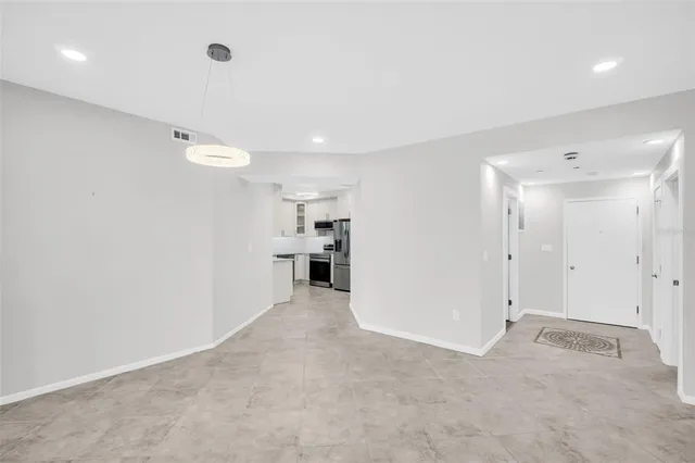 a view of a kitchen with refrigerator and a sink