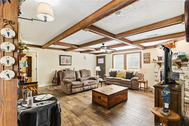 a living room with furniture a fireplace and a flat screen tv