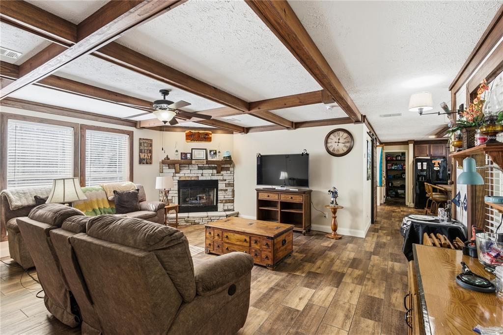 7970 Southwest 14th Place Bell, FL 32619 - Photo 12 of 45 a living room with furniture a fireplace and a flat screen tv