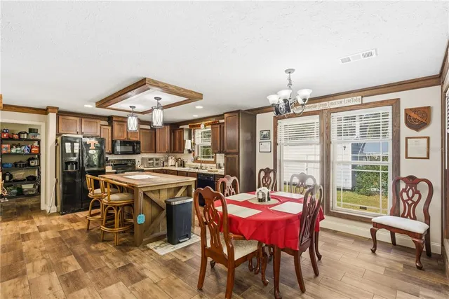 a kitchen with stainless steel appliances granite countertop a sink a stove and a refrigerator