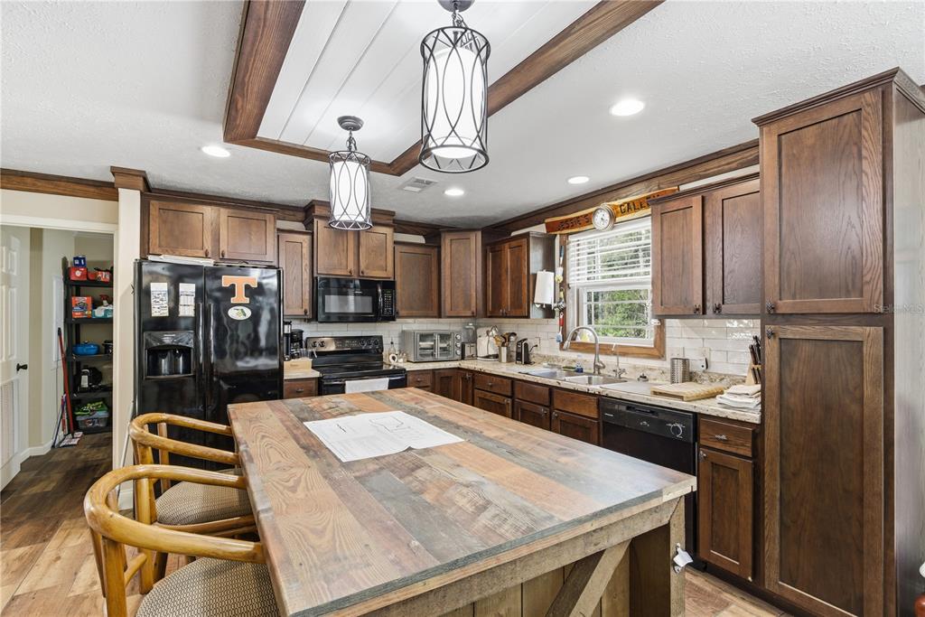 7970 Southwest 14th Place Bell, FL 32619 - Photo 18 of 45 a kitchen with stainless steel appliances granite countertop a sink a stove and a refrigerator