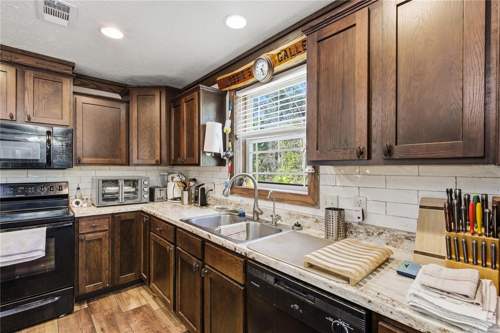 7970 Southwest 14th Place Bell, FL 32619 - Photo 23 of 45 a kitchen with a sink cabinets and window