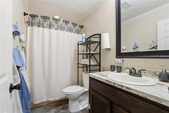 a bedroom with a bed and ceiling fan